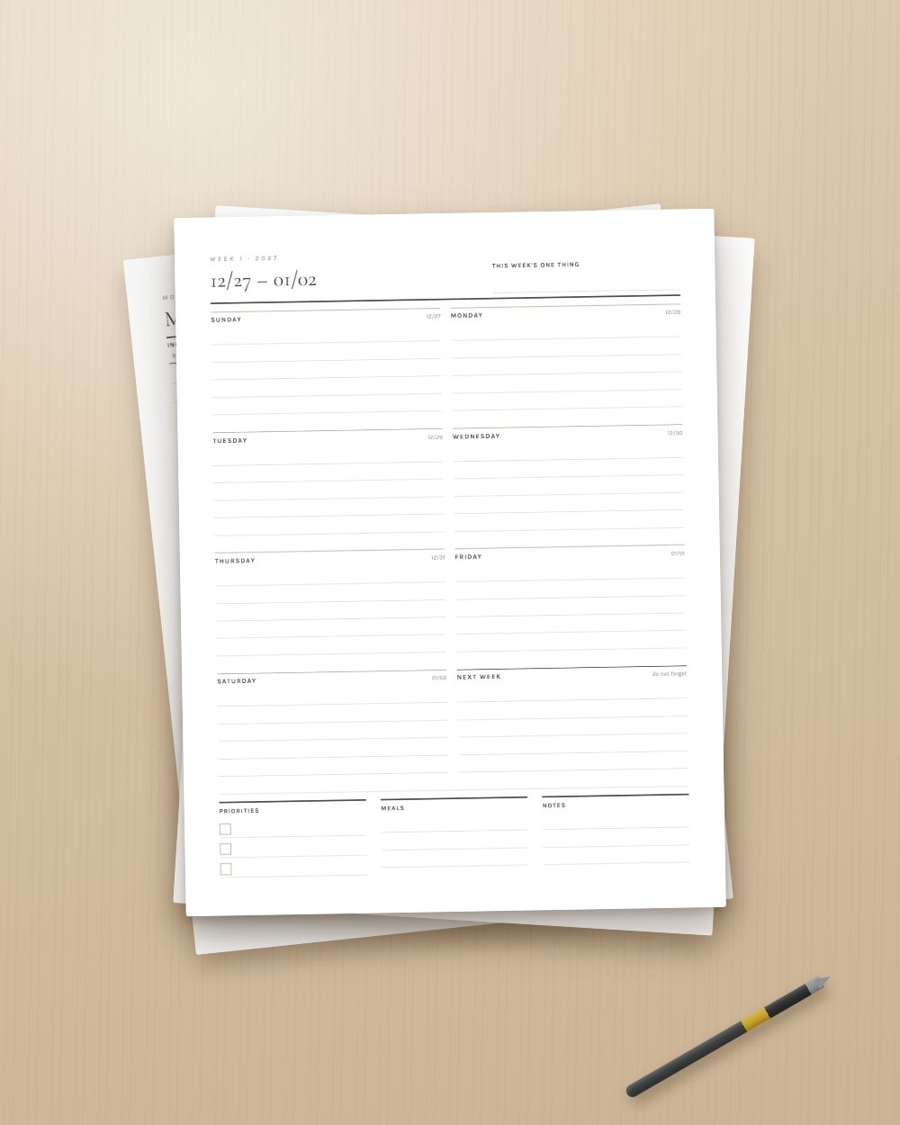 Loose printed pages of the planner on a desk